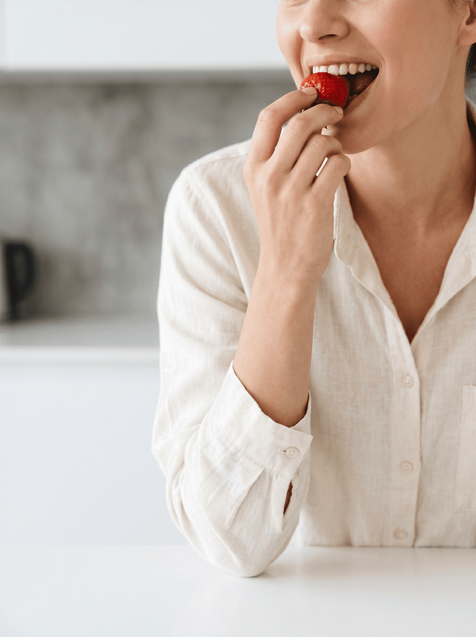 Woman enjoying a fresh strawberry